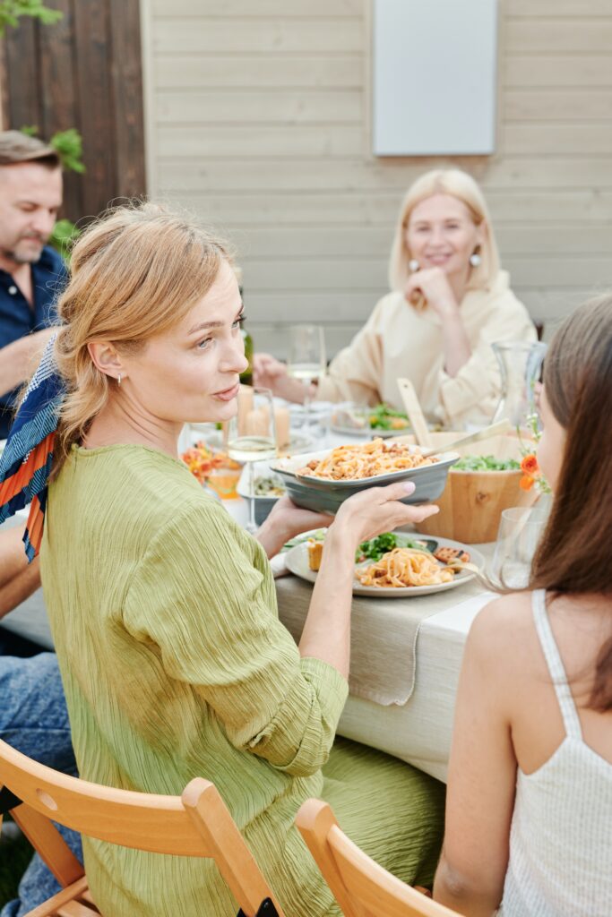A family sitting outside for a family barbecue