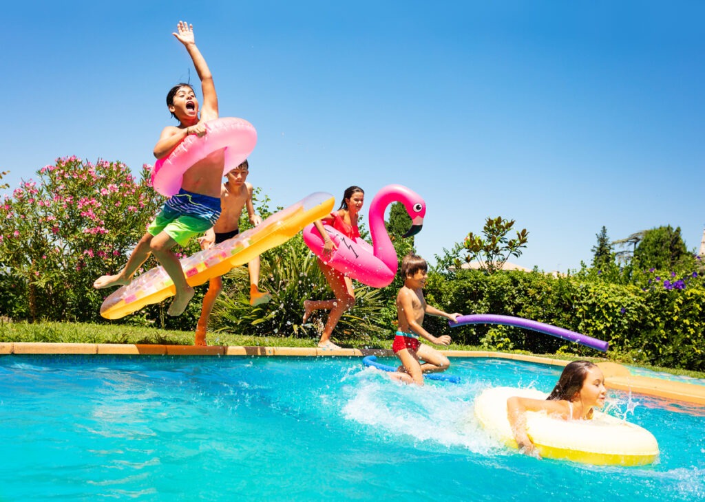 A group of kids jumping on the pool