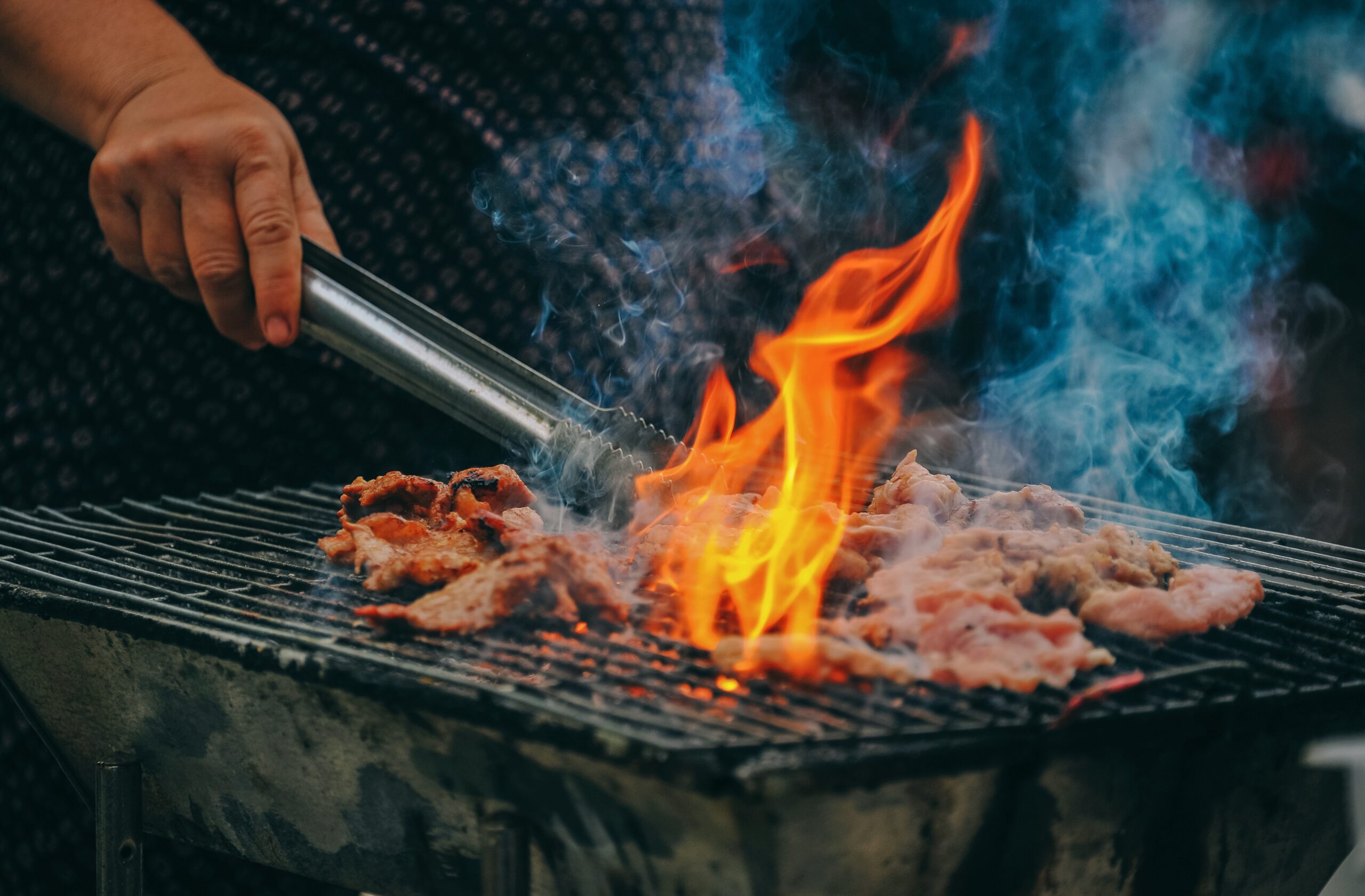 Close-up of a man barbecuing meat