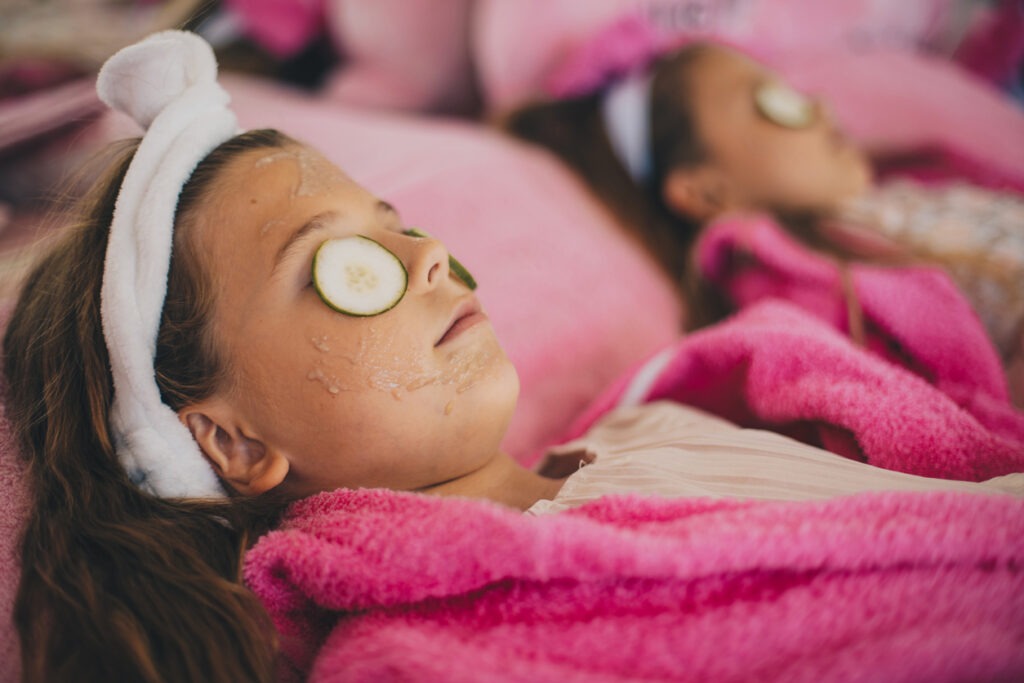 Little girls receiving a spa face treatment