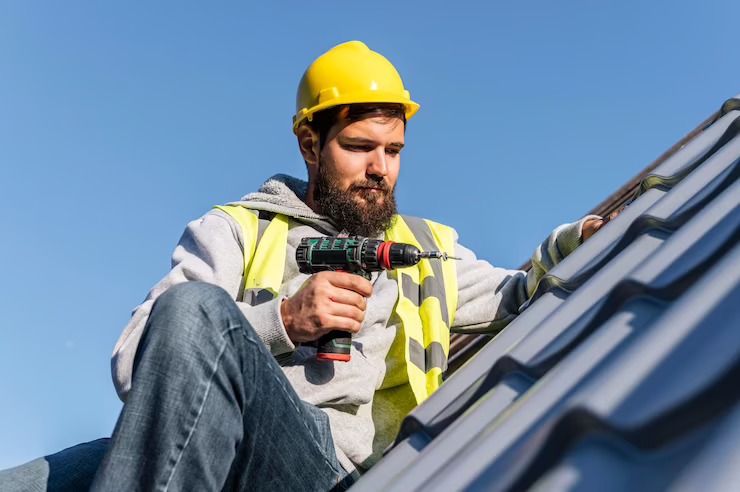 Roofer Drilling a hole in roof image