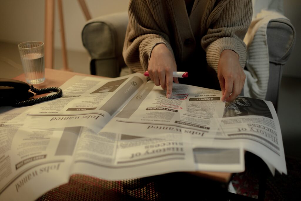  A woman searching for jobs in a newspaper