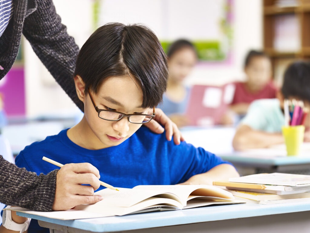 boy studying in classroom image