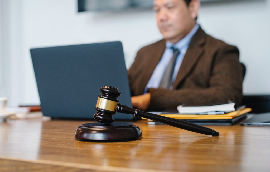 judge working on laptop in office image