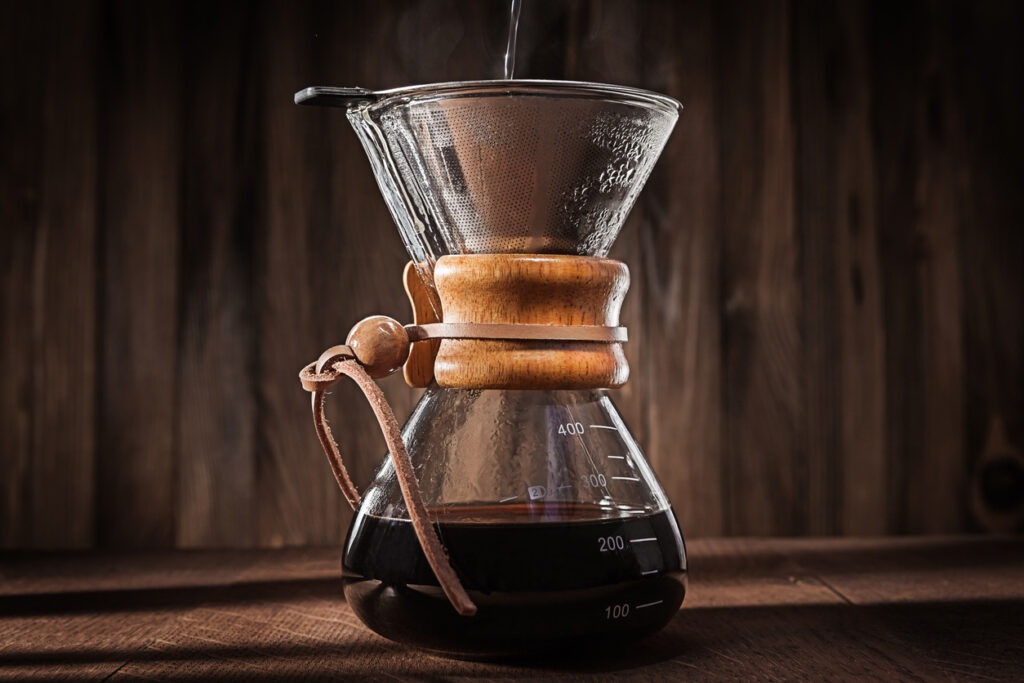 An Image of Hot water pouring into glass coffee dripper