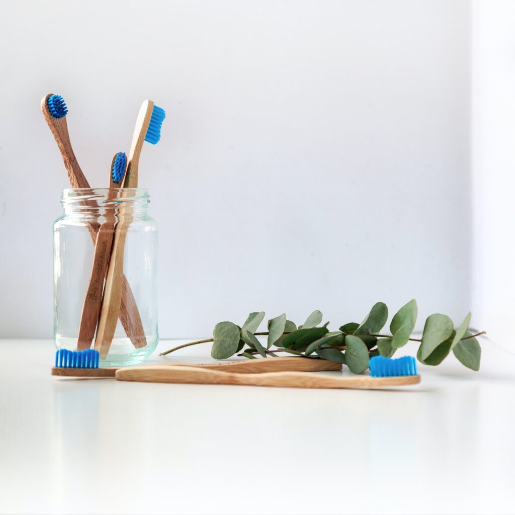 a jar of three wooden toothbrushes image