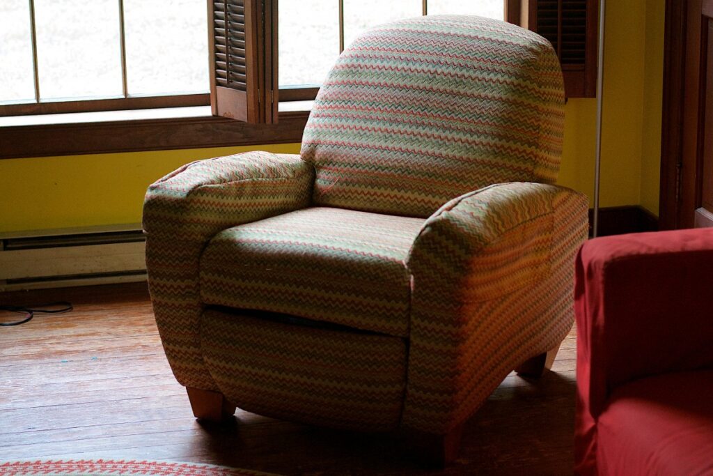 A recliner chair covered in colorful fabric image