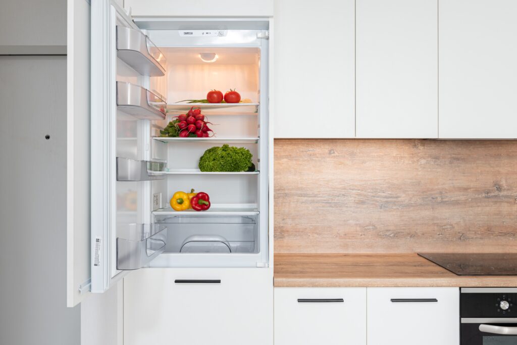 An open refrigerator with vegetables inside image