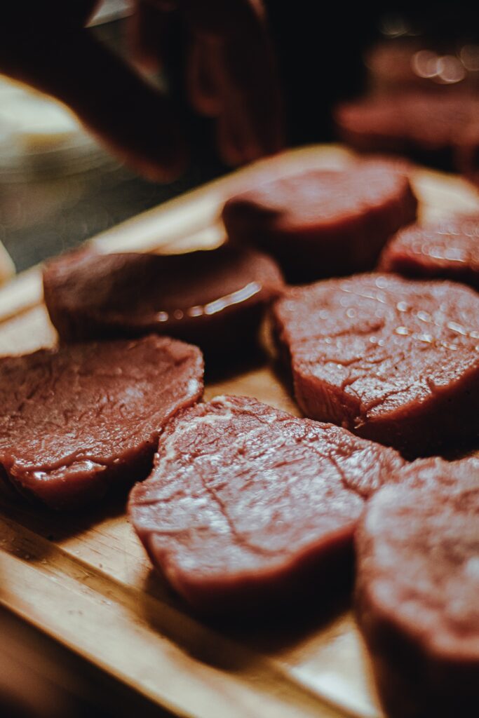 Closeup of meat on a wooden plate image