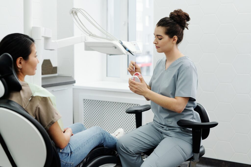 Dentist Pointing At A Dental Model image