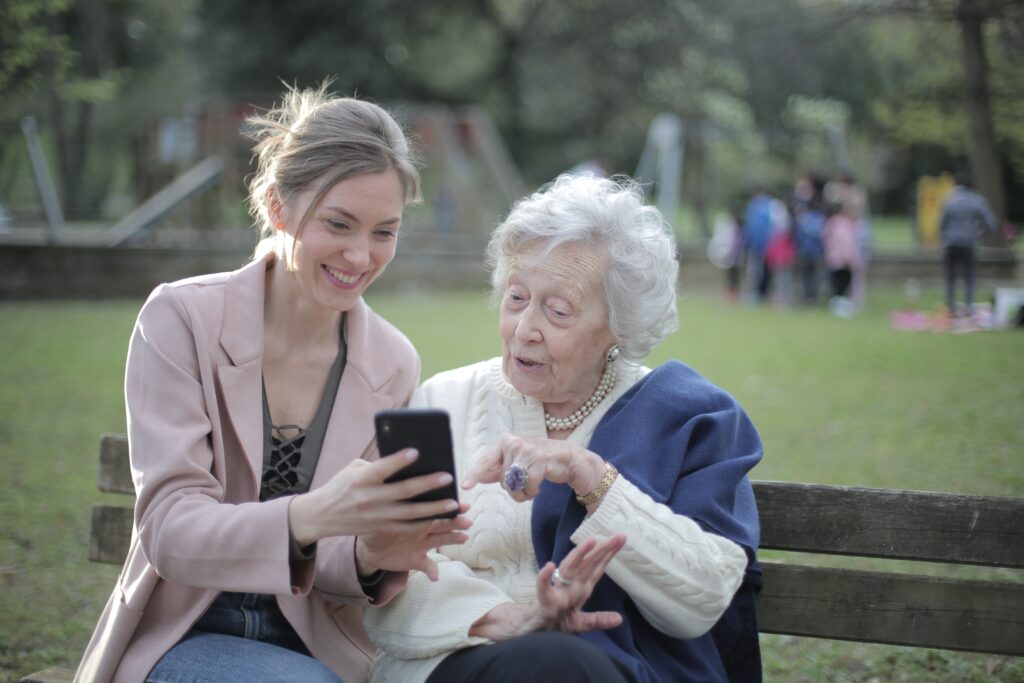 Mother and daughter laughing while looking at a smartphone image
