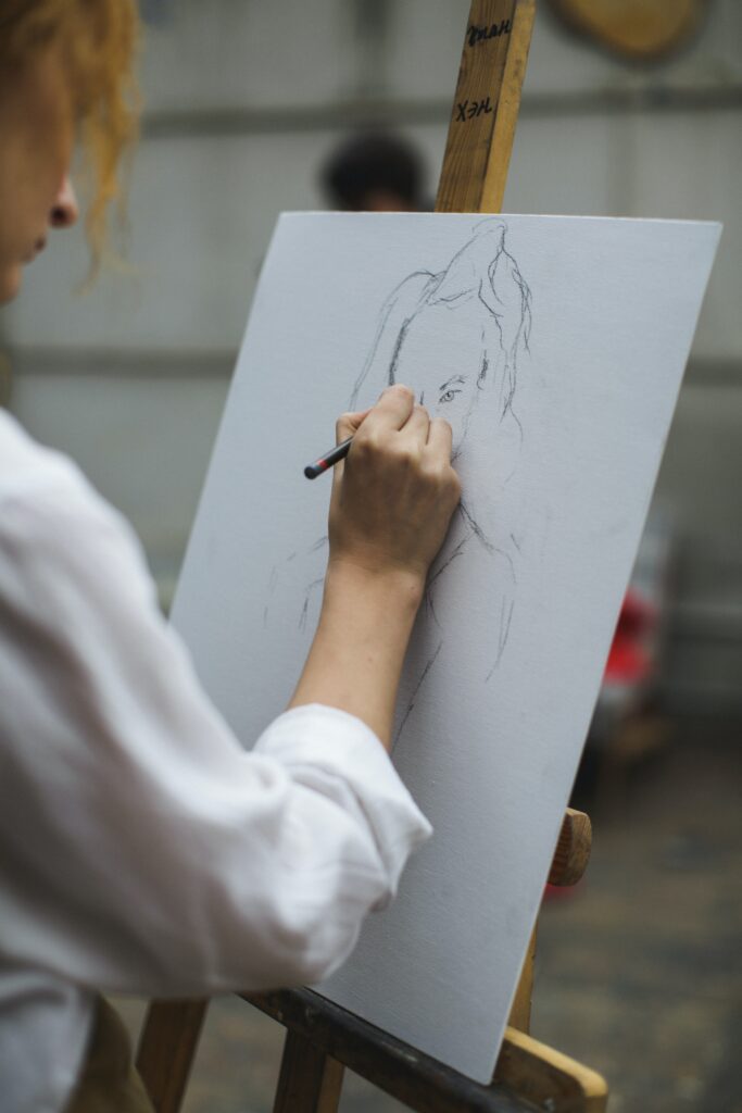  image of an artist sketching on a paper