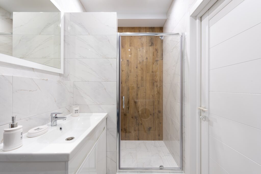 bathroom interior with wash basin and glass door image