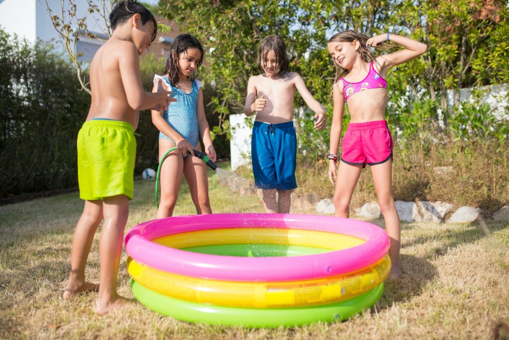 Kids Standing Around a Kiddie Pool