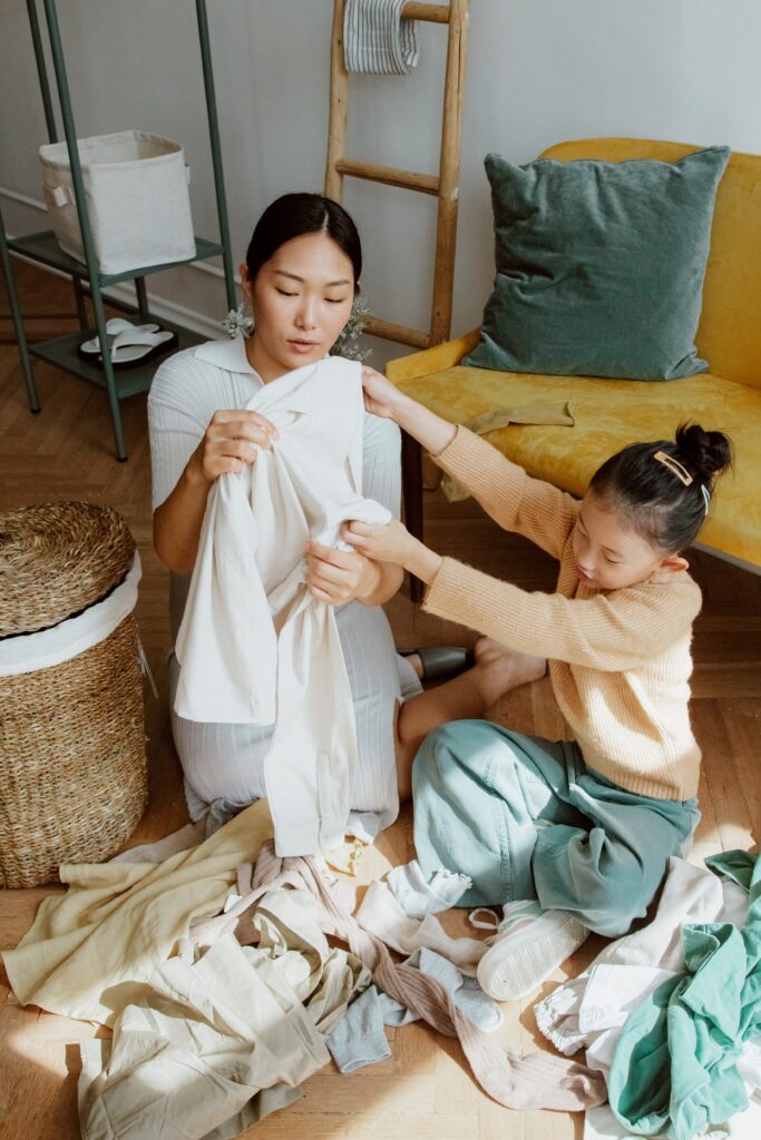 Mother organizing clothes with daughter image
