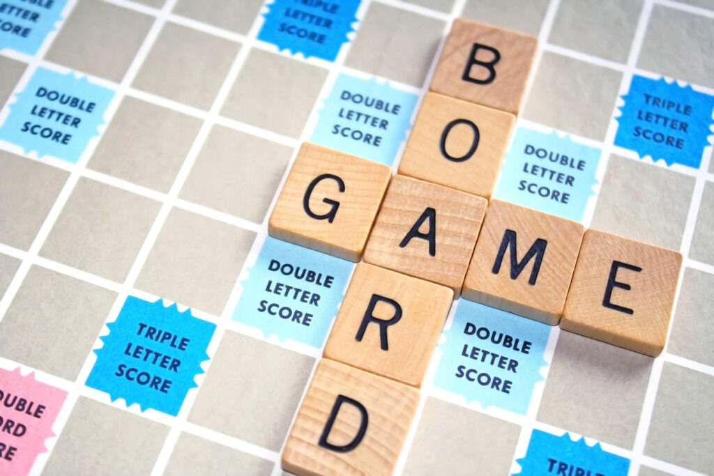 A Scrabble board with “board” and “game” words at the board