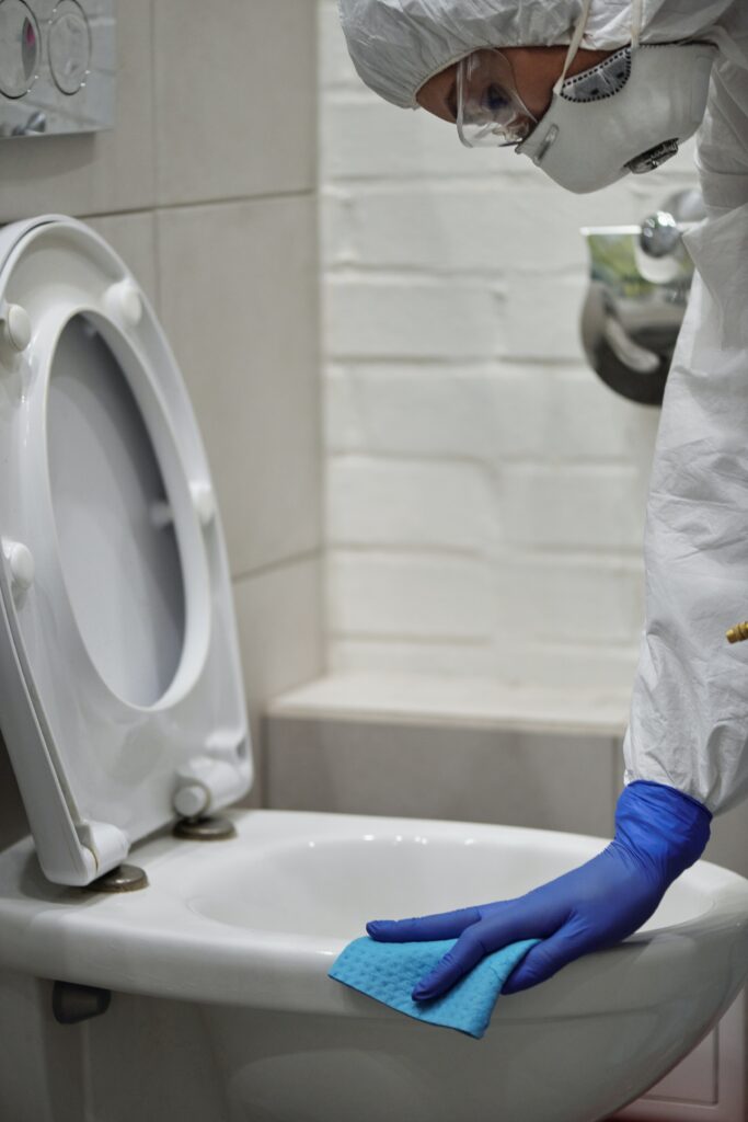 person cleaning toilet bowl image