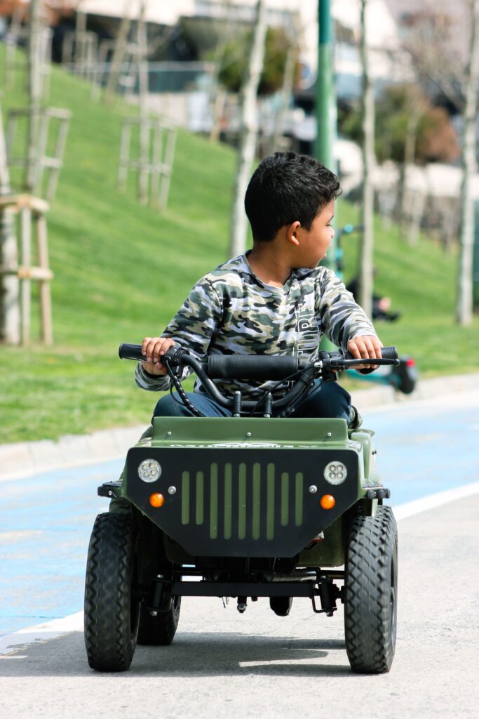 a boy riding a car toy