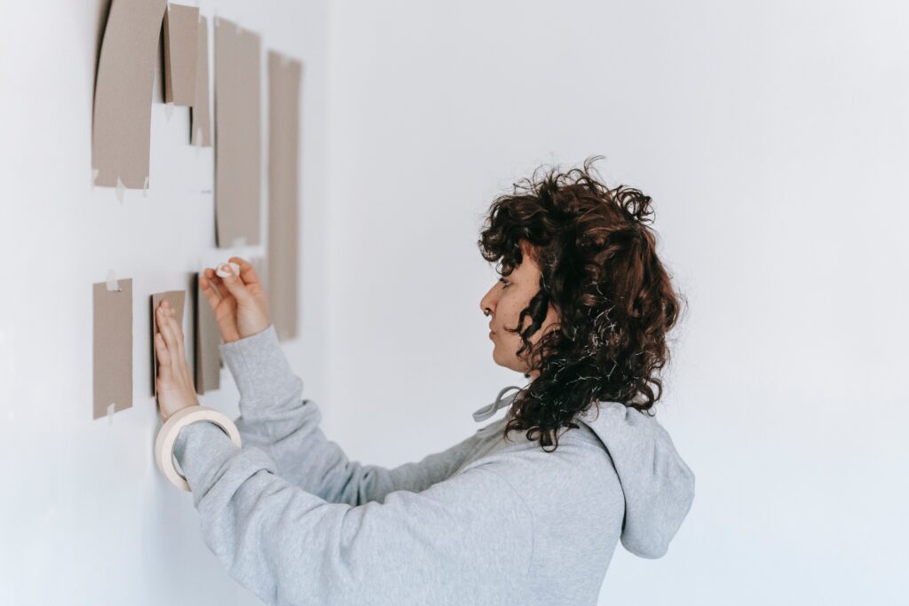 woman redecorates her wall image