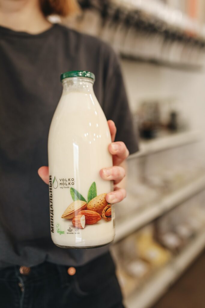 A person holding a bottle of almond milk image