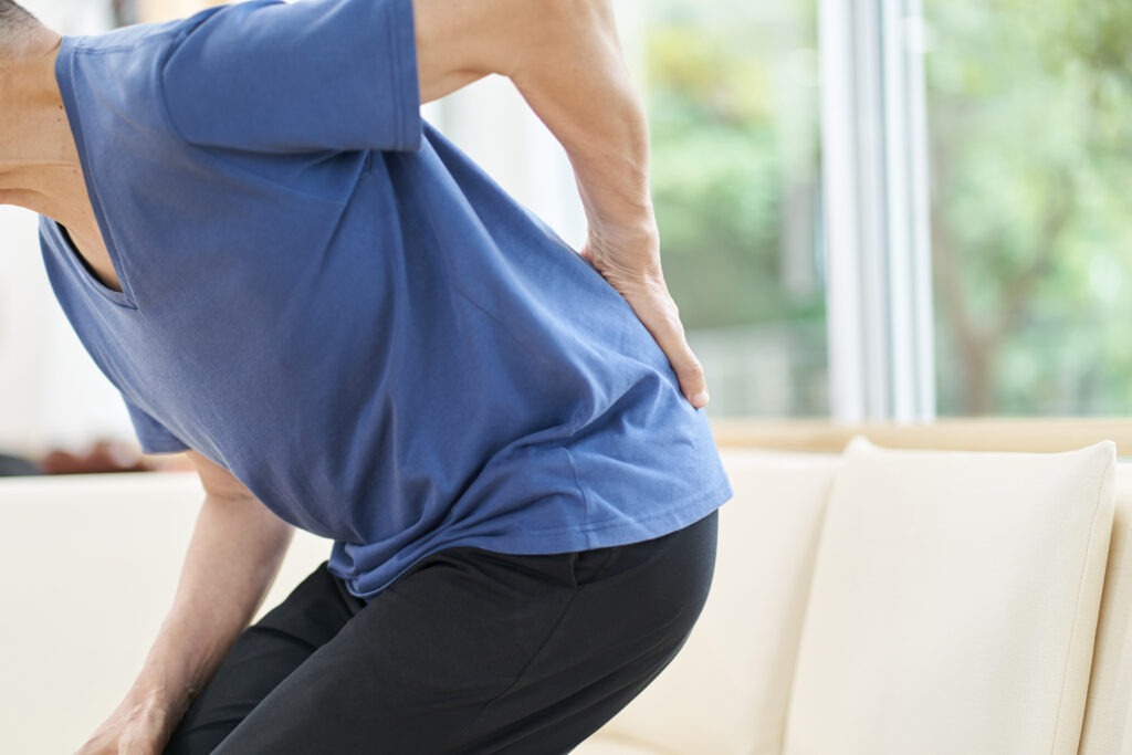 Elderly people with lower back pain image
