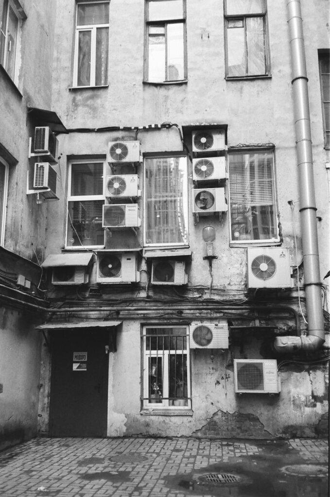 Air conditioners on an old building in the backyard