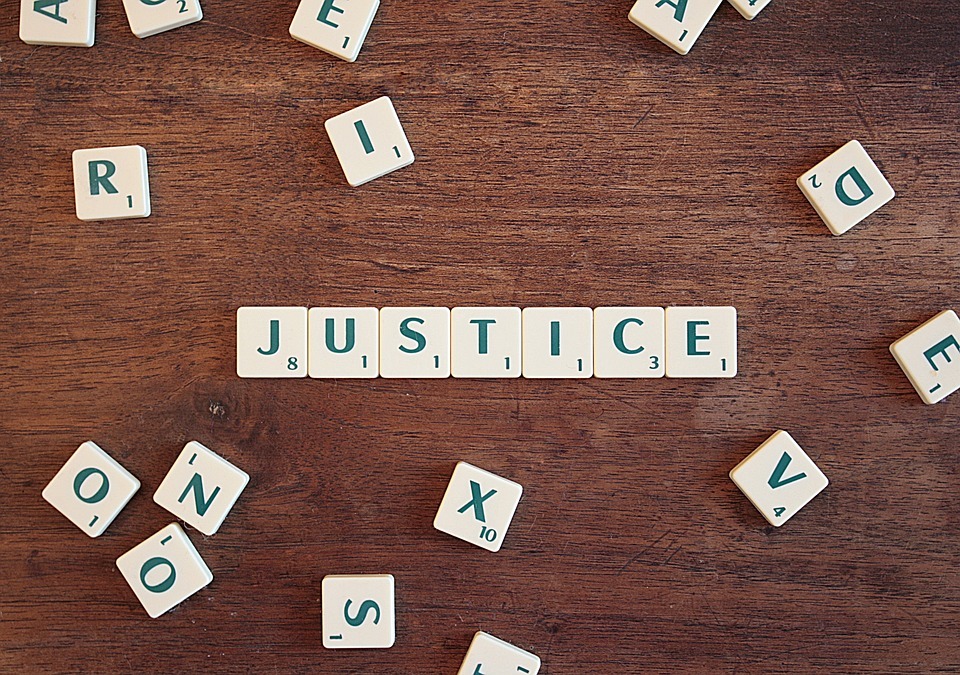 Scrabble letters spelling out the word ‘Justice’ image