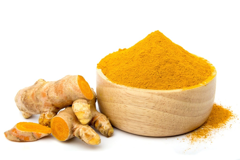 An Image of Turmeric powder in a wooden cup