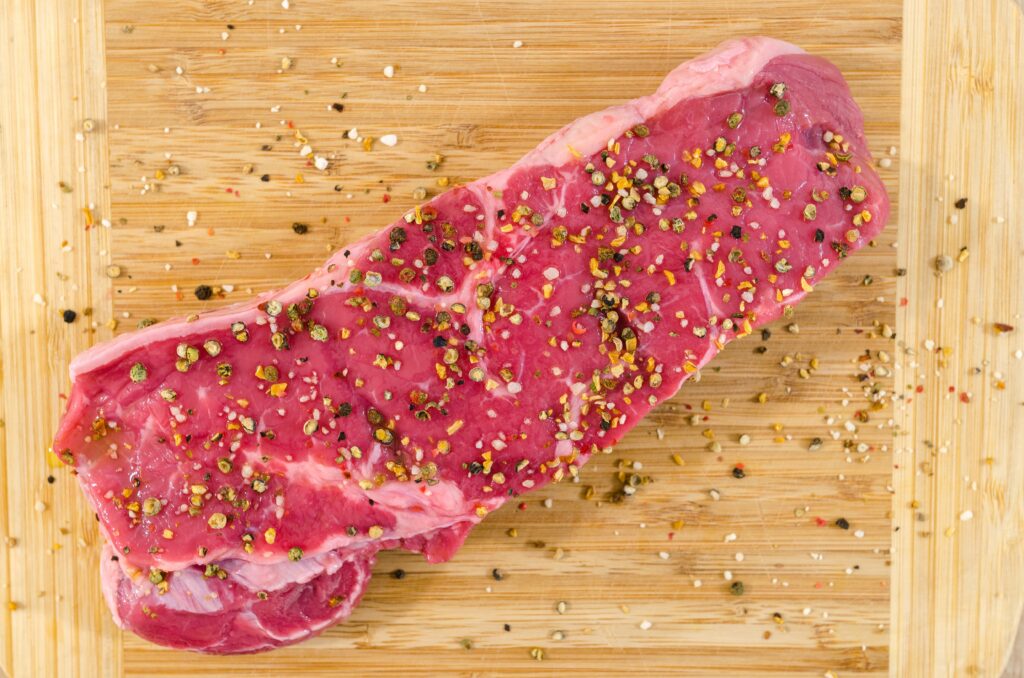 raw meat on a beige wooden surface image