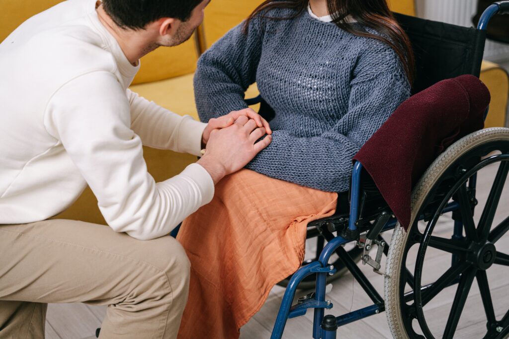 An Image of a Woman with disability and a man holding hands