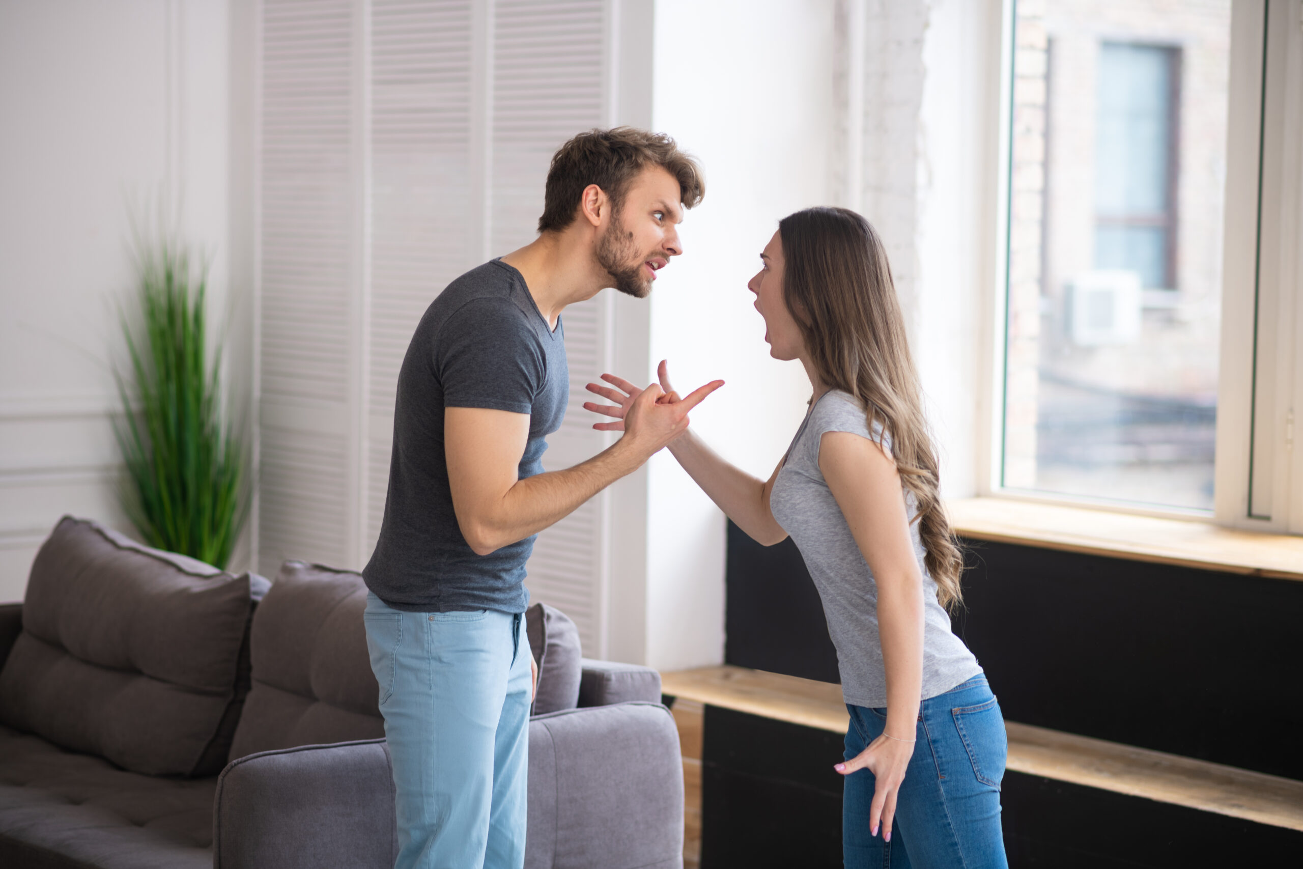 Young couple having a quarrel and shouting at each other