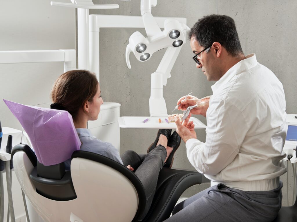  a patient and a dentist having dental consultation image