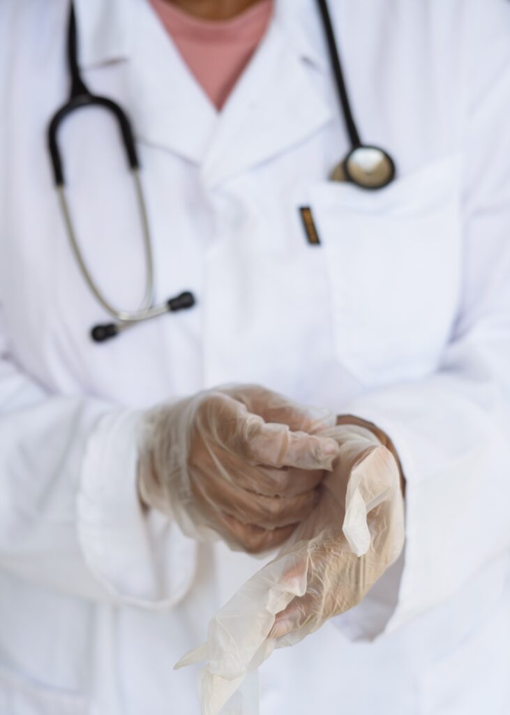 A doctor putting on gloves image