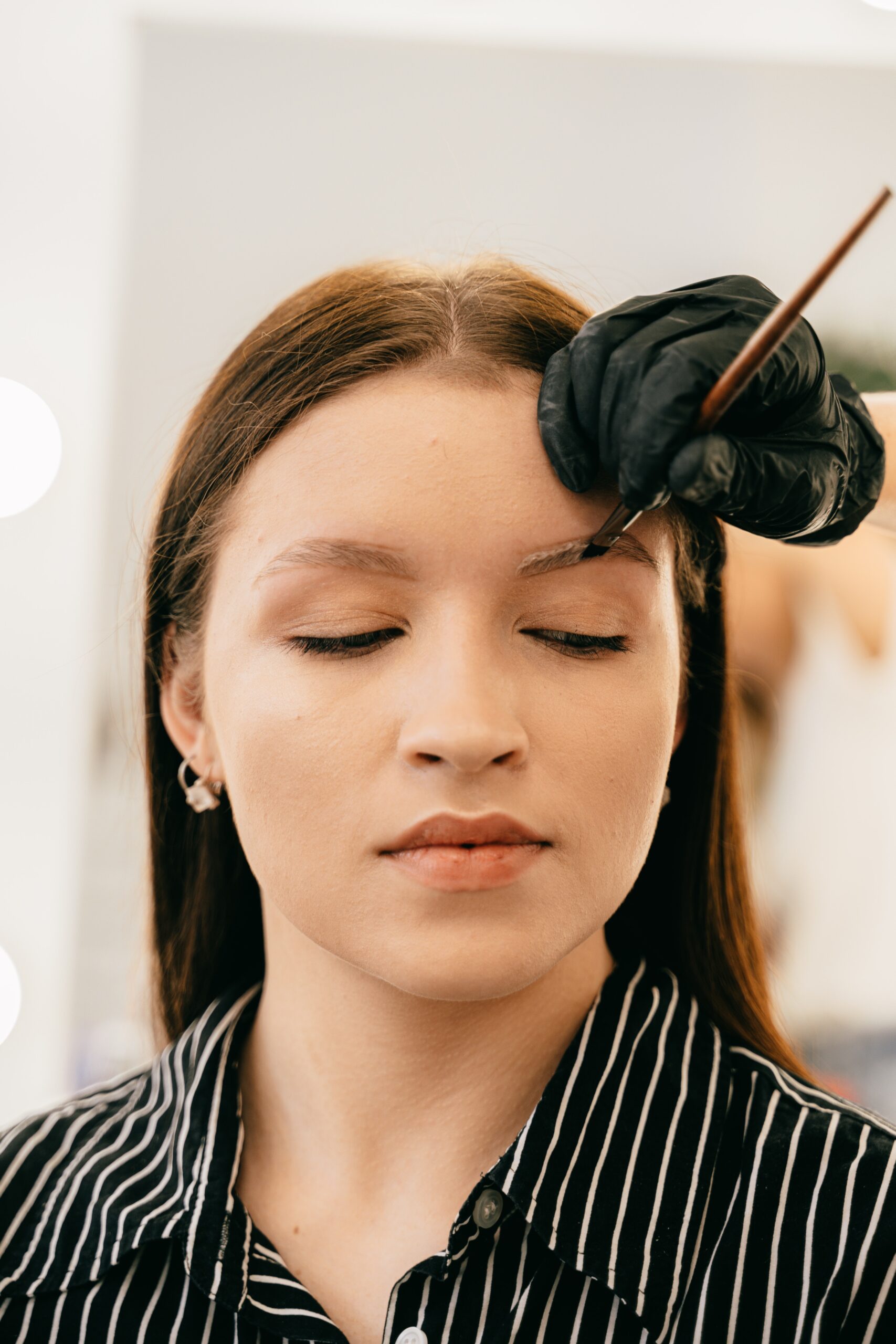 A woman getting microblading done image