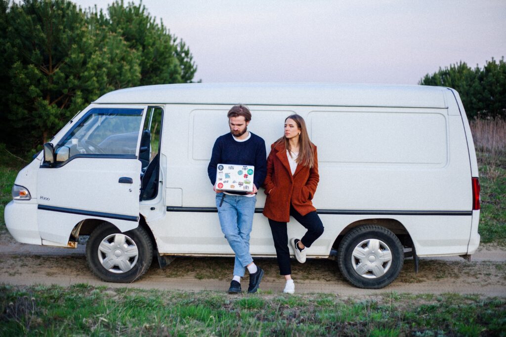 Woman and A Man Leaning On A White Van image