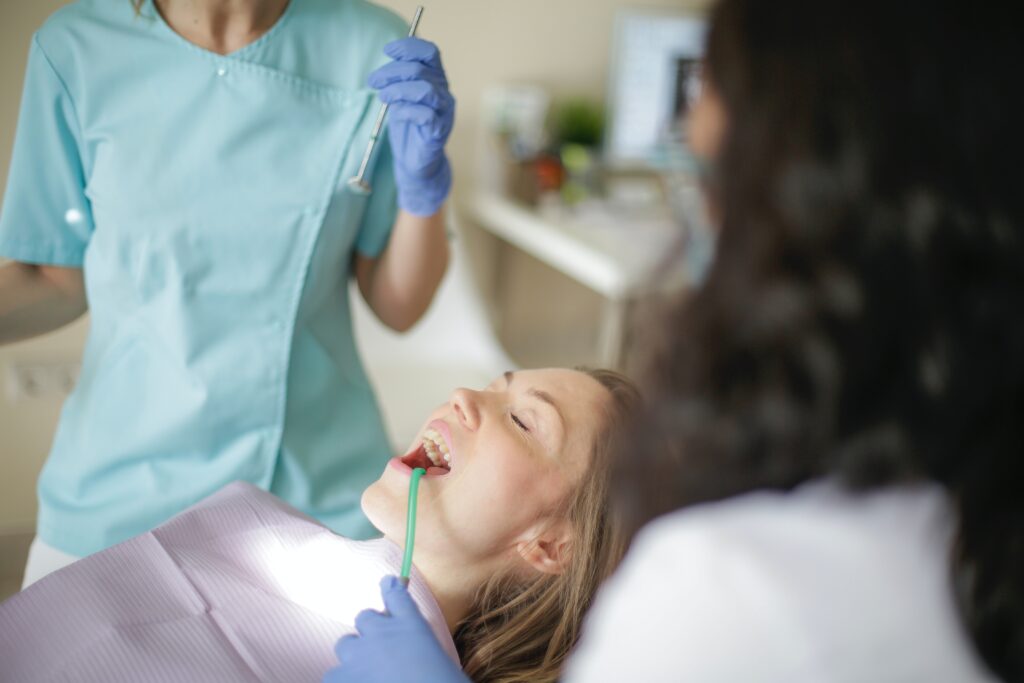 dentist-with-assistant-preparing-for-inspecting-patient-teeth image