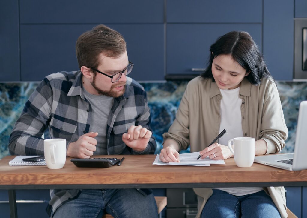 man-and-woman-sitting-at-table-with-documents image