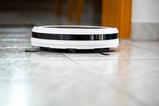 A robot vacuum cleaner on tiled flooring image