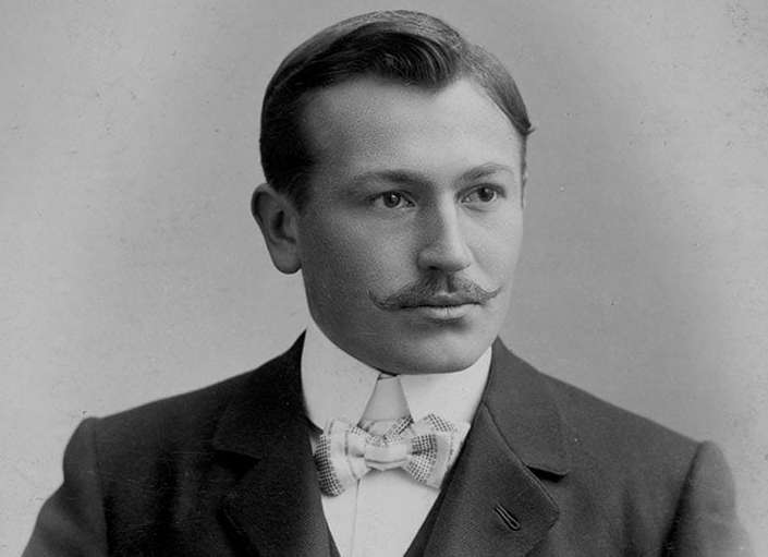  a portrait of Hans Wilsdorf, wearing a suit in a black and white color image