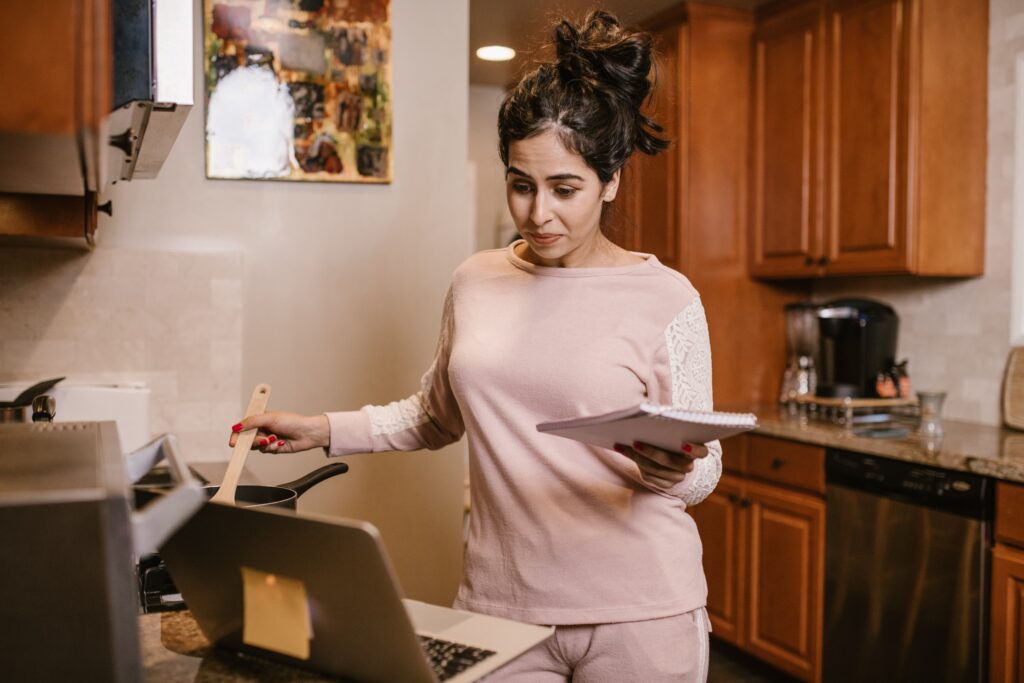 A woman taking an online cooking class