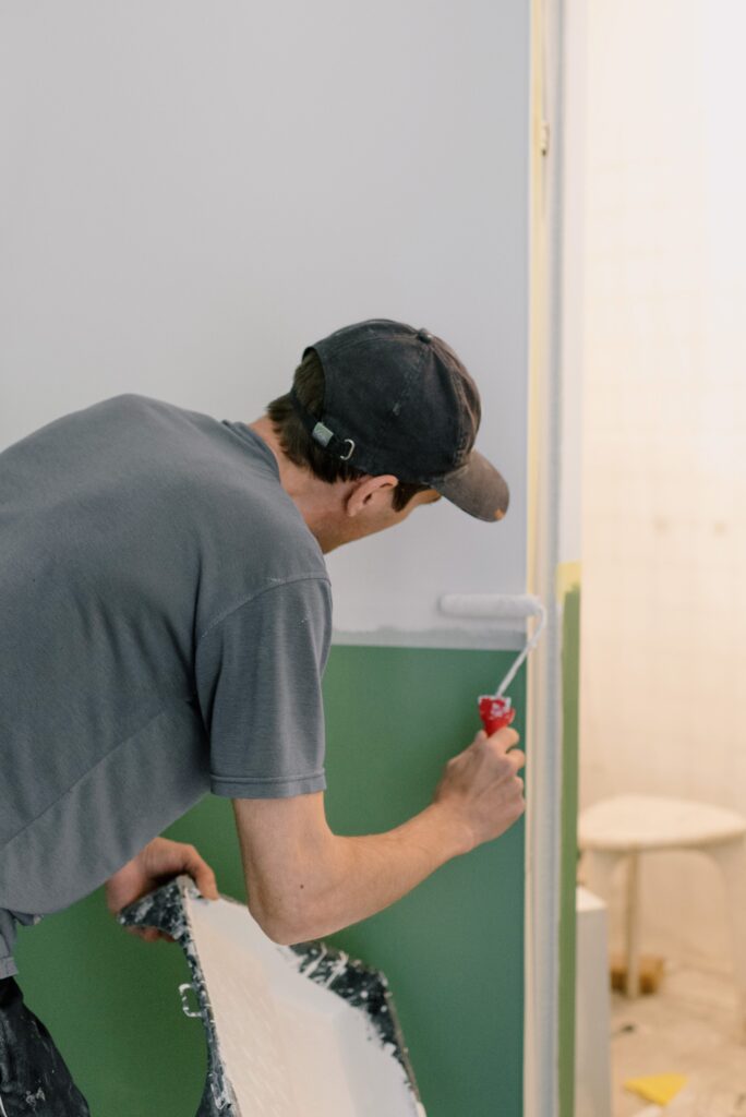 a professional painting an interior wall