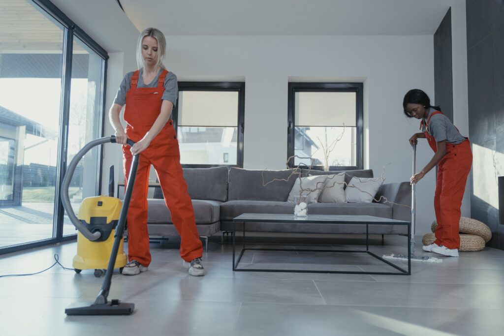 women-in-orange-uniform-cleaning-the-floor image