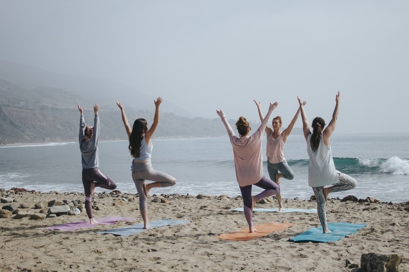 women yoga beach