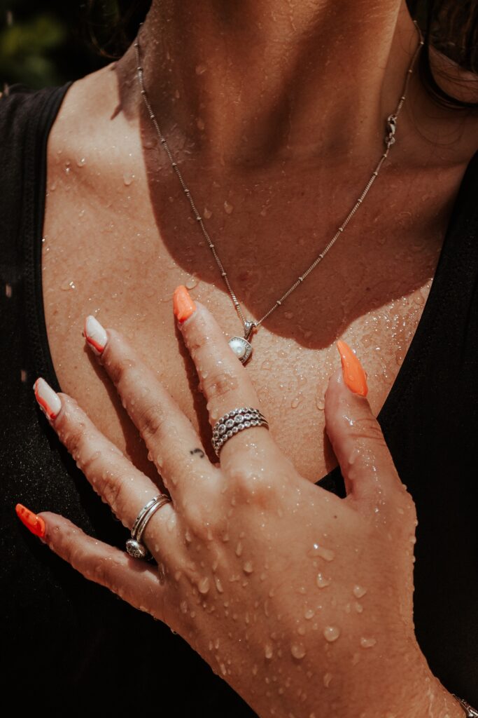 A Wet Woman in Black Top Wearing Jewelries image