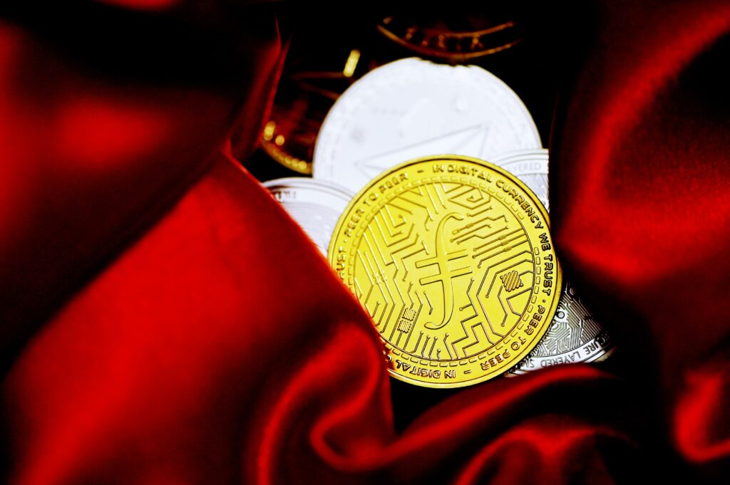 a bitcoin sitting on top of a red cloth image
