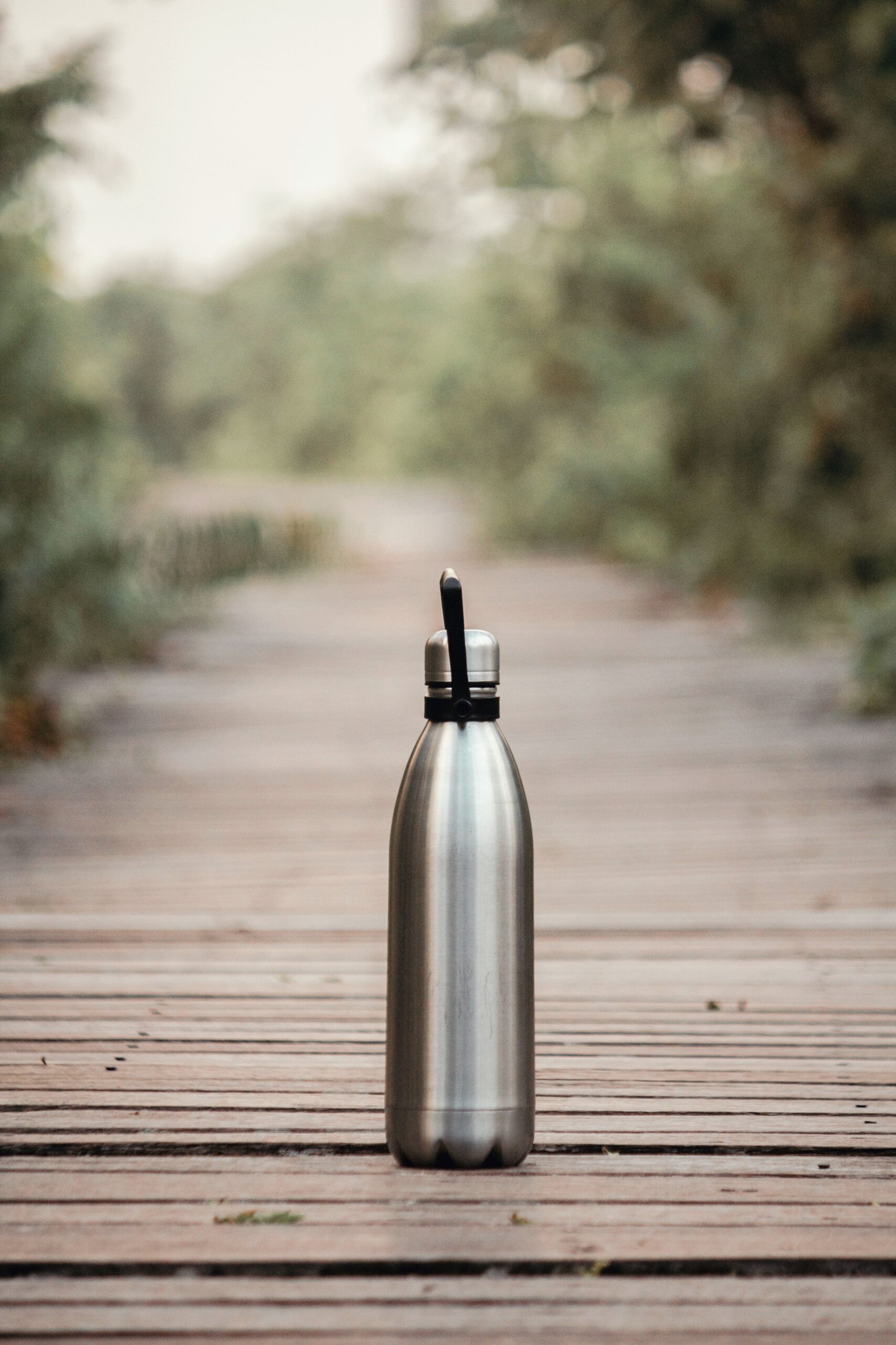 An insulated water bottle on a wooden deck