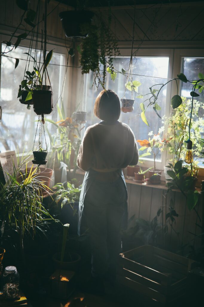 An Image of A woman staring at potted plants
