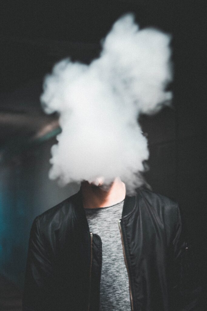  a person vaping with white smoke image