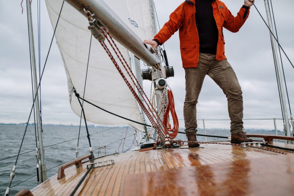 A person standing on a deck of a boat image