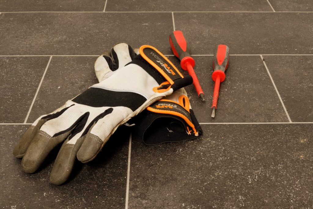 a pair of gloves with 2 screwdrivers